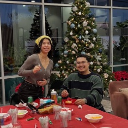 two people posing at a Christmas party