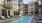 a pool in a courtyard between buildings