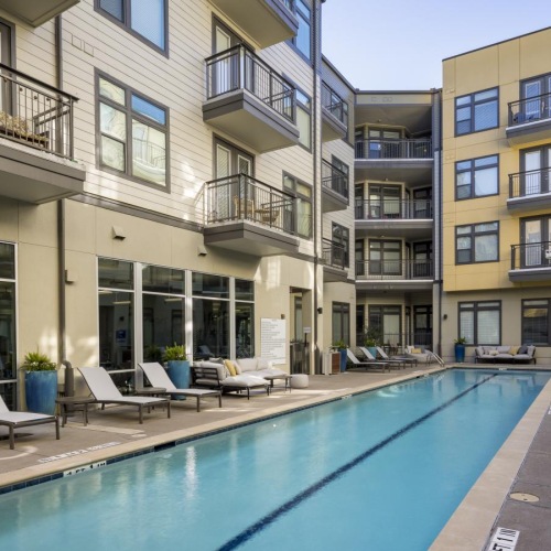 a pool in a courtyard between buildings